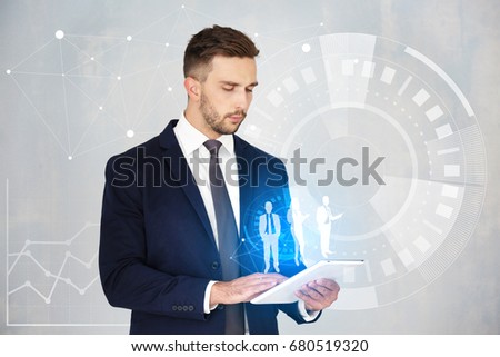 Concept of management information systems. Young man using tablet on light background