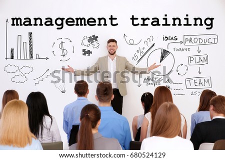 Concept of management training programs. Business trainer with team of managers at conference in office Royalty-Free Stock Photo #680524129