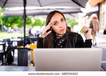 Girl working at her laptop in cafe