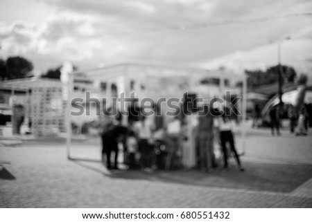 People / Family in a recreation park. Blur people picnic in public park with family or friends, urban leisure lifestyle.Defocused  background.Relaxation and recreation concept.Black and white photo