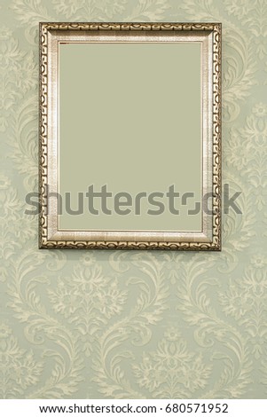 gold frame mirror on green golden wall