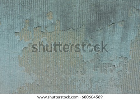 An abstract detail of a faded blue painted wall.