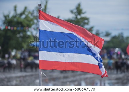 Thai flag with blurred people in the the Buffalo Racing Festival 2017 in Chonburi