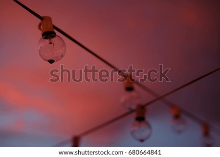 close up of party string lights with vivid colorful sunset background