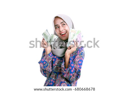 The veiled woman is excited to keep some money in hand