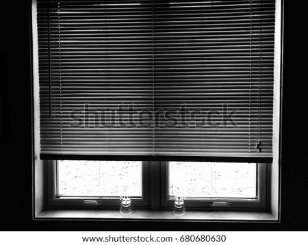 Windows with blinds and wood lamps A black and white photo