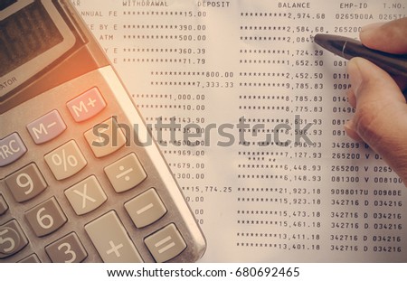 Calculator on Statement with hand writing account receivable and payable for saving money