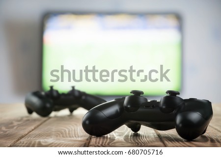 Gamepads on the table Royalty-Free Stock Photo #680705716