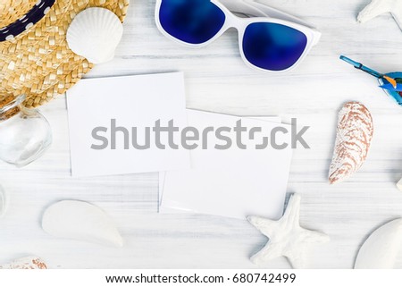 Summer Beach accessories (White sunglasses,starfish,straw hat,shell) and photo frame on white plaster wood table top view,Summer vacation concept,Leave space for adding your photo.