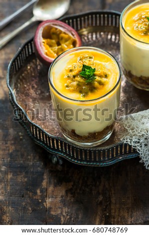 Passion fruit cheesecake dessert pots garnished with fresh mint