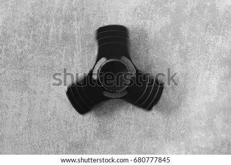 Hand spinner. A fidget toy for increased focus, stress relief on gray concrete background
