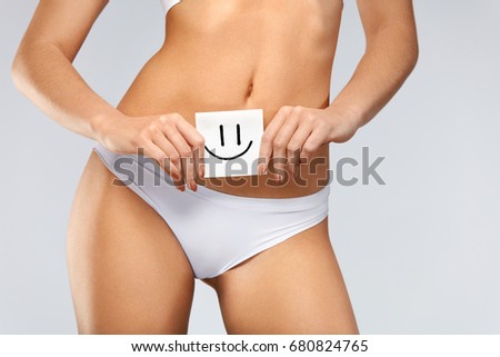 Women Health. Closeup Of Healthy Female With Beautiful Fit Slim Body In White Panties Holding White Card With Happy Smiley Face In Hands. Stomach Health And Good Digestion Concepts. High Resolution 