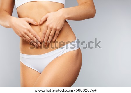 Female Health Care. Closeup Healthy Young Woman With Beautiful Fit Slim Body, Perfect Smooth Soft Skin In White Panties Holding Hands On Stomach. Good Digestion, Women Health Concept. High Resolution