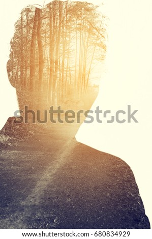 Creative double exposure portrait of young man combined with photograph of nature
