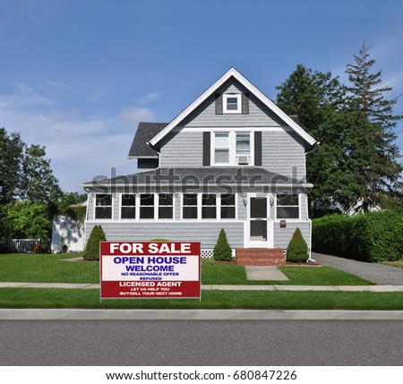 Real Estate For Sale Sign Beautiful gray suburban home blue sky clouds USA