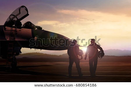Military pilots on airfield during sunset Royalty-Free Stock Photo #680854186