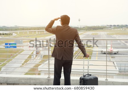 indian business male looking at flights