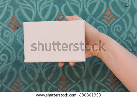 Hand Holding a Tiny Canvas