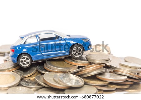 blue car model on pile of coin