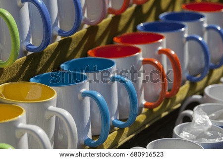 Colored mugs for sale at a tourist shop near the Great Wall of China