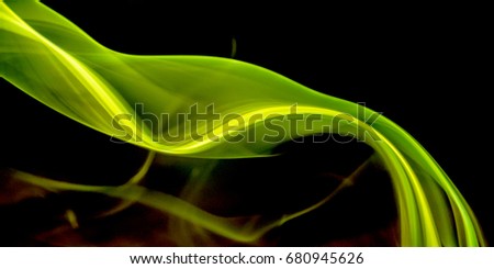 Thick, scenic clouds of smoke. From incense, or cigarettes, or cigars. In the rays of sunshine on a dark background. Isolated on black. Psychedelic mood. Close up. Colorful abstract background.