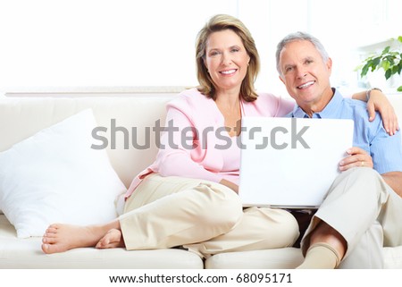 Senior couple  working with laptop at home
