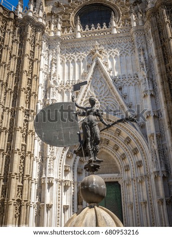 The lady of faith at the entrance of the seville cathedral