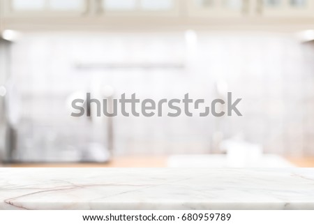 Marble stone countertop on blur kitchen interior background - can be used for display your products or food