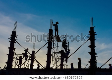 Silhouette Workers under Building Construction