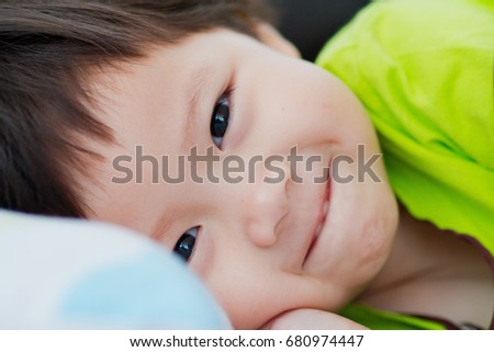 asian child smile on her bed and happy
