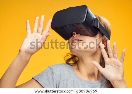Woman in 3d glasses on a yellow background                               