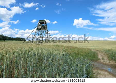 A picture from czech nature, the field with a raised hide during the nice summer day.