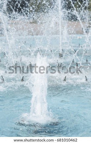 Fountain and water splashes close-up, vertical frame