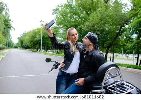 couple makes selfi on a motorcycle.