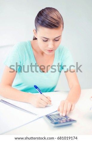 picture of student girl with notebook and calculator