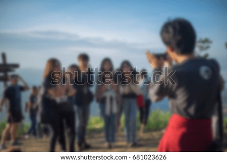 Blurry images for the background in group of people are taking a picture of the atmosphere atop a hill.