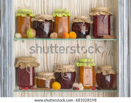 Jars with jam on the kitchen shelves Royalty-Free Stock Photo #681028198