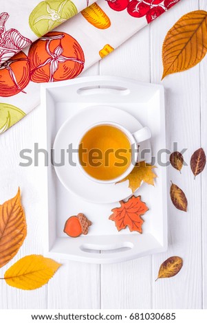 Autumn composition. Herbal tea, gingerbread and dry autumn leaves on a white background. Top view