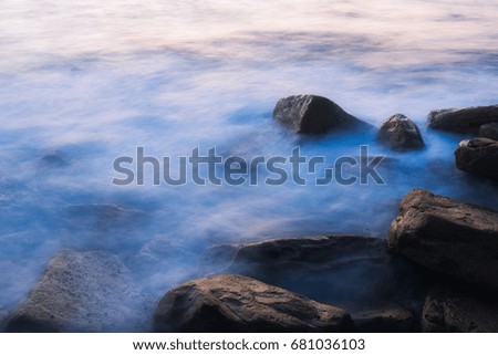 Ethereal looks of water flowing into rocks.