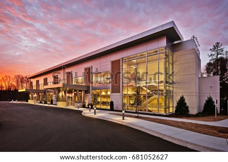 Generic Modern Stylish Office Executive Retail Building Exterior With Stone and Metal walls and Large Glass Windows And Brick Accents Royalty-Free Stock Photo #681052627