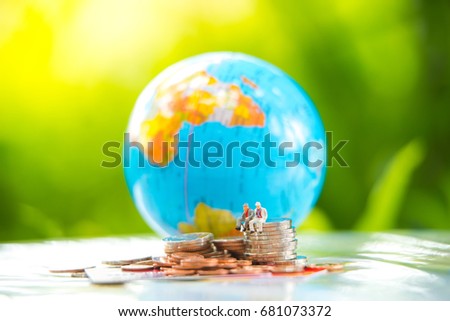 Miniature businessman sitting on stack coins with credit card using as background commitment, agreement, investment, business and partnership concept