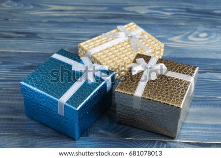 Gift boxes on a wooden background. Greeting card. Discounts and sales.
