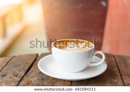 coffee cup Latte art on old vintage blue wood table outdoor with copy space for text