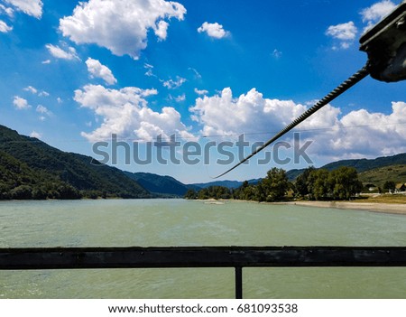 A cable stretches across the Danube River to guide a ferry boat