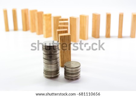 Sorting coins and wooden domino block two way in business concept " The different direction of finance