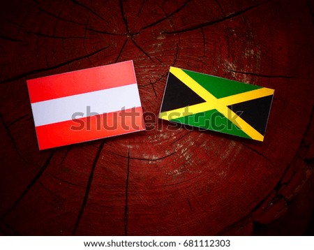 Austrian flag with Jamaican flag on a tree stump isolated