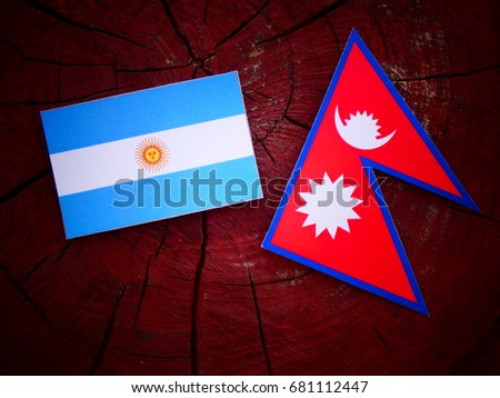 Argentinian flag with Nepali flag on a tree stump isolated