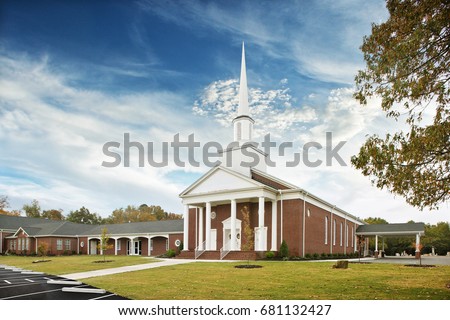 White and Brown Baptist Church Exterior with White Steeple tower, religion, God, Priest Royalty-Free Stock Photo #681132427