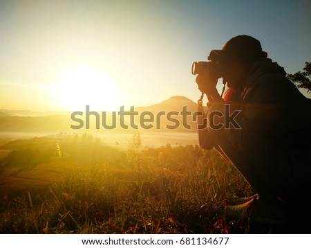 Photographer Silhouette take a view photo, taking pictures of the beautiful moments during the sunset ,sunrise.