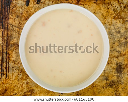 Bowl of Cream of Chicken Soup Against a Distressed Used Oven Tray